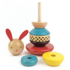 an assortment of wooden toys including a toy rabbit and other items on a white background