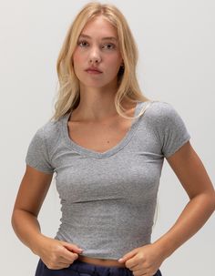 Tilly's V-Neck Rib Tee. V-Neckline. Rib Knit Construction. Short Sleeves. Breathable And Lightweight Fabric. 60% Cotton, 35% Polyester, 5% Spandex. Machine Wash. Imported. Model Is Wearing A Size 26. Model Measurements:height: 5'8" Bust: 32"waist: 25"hips: 35" | Tillys V-Neck Rib Tee Cheap Ribbed V-neck T-shirt, Fitted V-neck Graphic Tee T-shirt, Trendy Stretch Cropped T-shirt With V-neck, Tillys Graphic Tees, Cotton V-neck Graphic Tee Tops, Wwe T Shirts, V Neck Shirts, Flannel Sweatshirt, Boys Graphic Tee