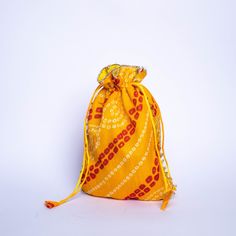 Bandhini is a beautiful fabric that requires hand-crafted skills. About a thousand years old, bandhini cloth involves a long process that can only be done by skilled artisans at by hand, producing beautiful dotted patterns. These bandhini potlis by Desi Favors will win your heart and turn heads at any and every occasion. Set of 4 colorful potlis that are perfect for return gifts during festivals or weddings Each potli bag is 9x7 inches in size Comes in four vibrant colors of pink, green, red and Bohemian Handmade Ceremonial Bags, Bohemian Bags For Navratri Gift, Traditional Handmade Bags For Festive Occasions, Bohemian Bags As Gifts For Navratri, Traditional Tilla Potli Bag For Festive Occasions, Traditional Handmade Festival Bags, Traditional Handmade Bags For Festival, Traditional Handmade Festive Bag, Traditional Handmade Festive Bags