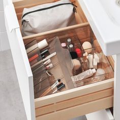 an open drawer filled with cosmetics and other items