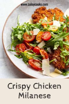 crispy chicken with tomatoes and arugula salad on a white plate text reads crispy chicken minanes