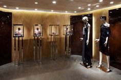 the display case is full of mannequins in black dresses