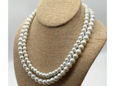 Introducing the epitome of timeless beauty, the Classic 2 Strand Pearl Necklace of Elegance! This exquisite necklace effortlessly combines classic charm with a modern twist, making it the perfect accessory for any special occasion. Crafted with two strands of genuine glass pearls, this necklace exudes an aura of elegance and sophistication that is simply unmatched. Whether you're heading out for a romantic dinner or attending a glamorous event, this timeless piece is guaranteed to elevate your o Classic Single Strand Beaded Necklace, Classic Adjustable Single Strand Beaded Necklace, Classic Double Strand Beaded Jewelry, Classic Double Strand Beaded Necklaces, Classic Double Strand Beaded Necklace, Classic Adjustable Beaded Necklace As Gift, Classic Polished Beaded Necklaces For Wedding, Classic Pearl White Beaded Necklaces For Jewelry Making, Classic Long Beaded Necklace For Gift