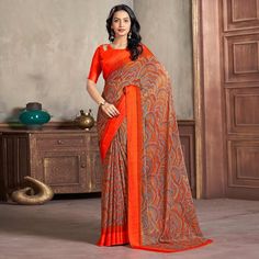 Orange colored saree is made from chiffon fabric which is highlighted with beautiful printed work as shown. Comes along with unstitched chiffon blouse piece which you can customise as per your design/style. Occasion - You can wear this saree for casual and daily wear. Note:- the actual product may differ slightly in color and design from the one illustrated in the images when compared with computer or mobile screen. Measurements: Saree : Chiffon : 5.5 Mtrs Blouse : Chiffon : 0.8 Mtr Material: Chiffon Stitch Type: Unstitched Country of Origin: India Care Guide: Dry Clean