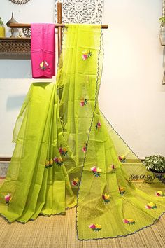 Embroidery work on green and yellow cross tone handloom resham cotton kota saree. Floral design has been neatly and densely done with multi color threads. The bright color combination and the scalloped border with all over floral motifs make this saree very elegant. this saree comes with an embroidered contrast cotton blouse piece. This saree is light weight, very comfortable & easy to drape. Details: *Fabric: Handloom Resham by cotton kota saree *Work: Machine Embroidery work [*this work is neither Computerized Machine Embroidery work nor machine Aari Embroidery with woolen thread. * It's completely Manual Machine Embroidery Work with silk threads.] *Blouse: With embroidered cotton blouse piece *Saree length: 5.5 mtrs *Saree width: 47 inches *Blouse piece length: 1 mtr *Blouse piece width Green Resham Embroidered Cotton Silk Blouse Piece, Pista Green Cotton Silk Saree With Resham Embroidery, Embroidered Green Cotton Silk Traditional Wear, Semi-stitched Green Embroidered Fabric With Self Design, Festive Cotton Saree With Chikankari Embroidery, Cotton Saree With Chikankari Embroidery, Green Handloom Cotton Silk Saree, Green Cotton Silk Handloom Saree, Green Embroidered Cotton Silk Dupatta