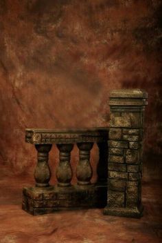 an artistic photo of a stone table and vases in front of a brown background