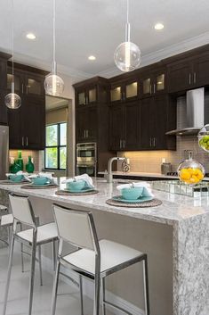 a kitchen filled with lots of counter space next to a dining room table and chairs