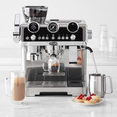 an espresso machine sitting on top of a white counter