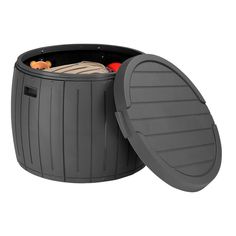 an outdoor storage box with the lid open and clothes in it's bottom compartment