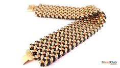 a gold and black tie with spikes on it