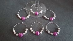 four wine glasses with some beads on them