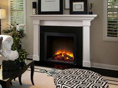 a living room with a fire place and pictures on the fireplace mantel above it