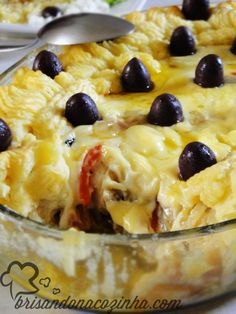 a casserole dish with olives and cheese in it, ready to be eaten