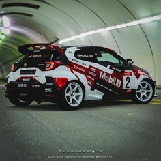 a white and red sports car driving through a tunnel