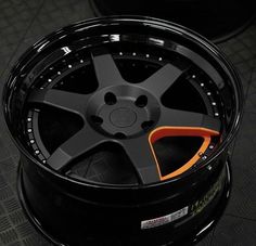 a close up of a tire on a car with black and orange trimmings