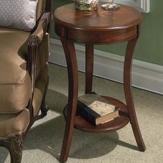 a wooden table with a book on it next to a chair