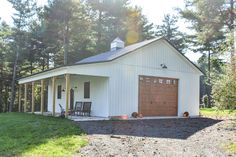 a small white building with a garage on the side