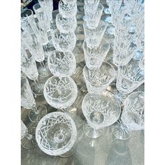 an assortment of crystal wine goblets on a table