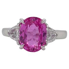 Ring contains one center GIA certified oval shape pink sapphire weighing 4.17ct. Center stone is accented by two side half moon cut diamonds weighing a total of 0.52cts. Pink Sapphire and diamonds are mounted in a handmade basket prong setting. Diamonds are F in color and VS2 in clarity. Pink sapphire measures 10.17x7.74mm and originates from Madagascar. Ring is a size 6.25 and can be resized to desired measurement. Please request customization. All of our pieces are packaged carefully and accom Gia Certified Oval Ruby Ring, Gia Certified Oval Pink Ruby Ring, Pink Oval Ruby Ring With Center Stone, Pink Oval Platinum Jewelry, Oval Pink Platinum Jewelry, Oval Ruby Ring With Brilliant Cut Pink Sapphire, Formal Pink Gia Certified Sapphire Ring, Luxury Pink Oval Sapphire Ring, Oval Pink Sapphire Ring With Center Stone