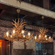 a chandelier made out of antlers hanging from the ceiling in a restaurant