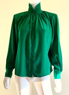 "Gorgeous vintage C1980s sumptuous, butter soft heavy silk long sleeved forest green blouse by Levante, featuring a nehru collar, front and back top pleats, and a front button closure under a hidden button placket. Approximate Measurements:        Chest, Waist, Hips: Up to 48\"; Length: 23\"        Labeled a size 6 Fabric:  100% silk Condition: Excellent, likely unworn, vintage condition." Nehru Collar Blouse, Collar Blouse, Green Blouse, Blouse Top, Button Placket, Vintage Tops, Forest Green, Blouses For Women, Top Blouse