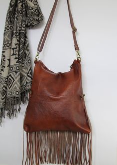 Bohemian fringe bag, cognac leather fringe bag, cognac brown boho bag, festival bag, leather crossbody, handmade leather bag This gorgeous bohemian style bag is crafted with a high quality suede leather and a cowchide leather. It has a top zip closure, and includes an inside pocket. It's cross body feature makes it suitable for a day or night occasion. Light in weight and unique. It is the perfect bag for every season. We use soft genuine leather. This bag is perfect as your everyday bag, which Bohemian Style Bag, Leather Fringe Bag, Handmade Leather Bag, Brown Leather Backpack, Leather Rucksack, Festival Bag, Fringe Bags, Cute Purses, Leather Bags Handmade