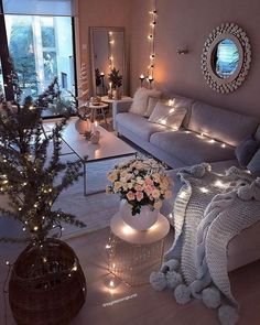 a living room filled with lots of furniture and christmas lights on the windows sill