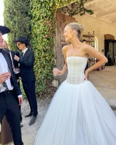 a woman in a white dress standing next to a man