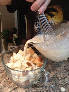 a person mixing food in a bowl with a whisk on the counter top