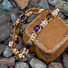 This wonderful link bracelet is accented with one (1), bezel set, oval cabochon cut natural peridot, three (3), bezel set, oval cabochon cut natural amethyst, three (3), bezel set, oval cabochon cut natural citrine, one (1), bezel set, oval cabochon cut natural garnet, one (1), bezel set, oval cabochon cut natural pink tourmaline, one (1), bezel set, oval cabochon cut natural green tourmaline and thirty (30), bead set, round brilliant cut diamonds. The bracelet measures 7mm wide and an overall l Vintage Amethyst Rings, Tourmaline Rings, Bezel Set Cabochon, Amethyst Rings, Pretty Accessories, Slide Bracelet, Bead Set, Safety Chain, Citrine Ring