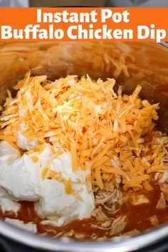 an instant pot buffalo chicken dip is shown with shredded cheese and sour cream on top