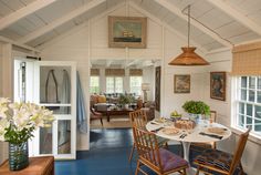 a dining room with blue floors and white walls