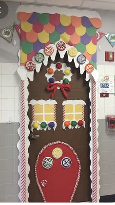 a door decorated to look like a gingerbread house with candy and lollipops