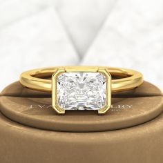 a gold ring with a princess cut diamond