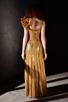 Golden yellow padded gown featuring hand sewn braids all over with a structured flower on the shoulder. - Aza Fashions Couture Sleeveless Gala Gown, Yellow Sleeveless Dresses For Reception, Luxury Yellow Gala Dress, Yellow Sleeveless Gown For Gala, Yellow Sleeveless Evening Gown, Sleeveless Yellow Evening Gown, Gold Sleeveless Reception Dress, Gowns Gold, Gown Gold