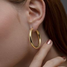 Look stylish and chic with these gorgeous gold hoop earrings! Perfect for any occasion, they are a must-have accessory for the contemporary fashionista. Our 14K Gold Plated Silver Hoop Earrings are handmade to perfection and feature 925 Sterling Silver. You can choose from gold, silver or rose gold colors, so you always have the perfect piece to match your outfit. Be trendy and fashionable wherever you go with this hoop earring jewelry set! Feel confident and beautiful with the perfect accessory Shiny Finish Hoop Earrings As Gift, Gift Hoop Earrings With Shiny Finish, Silver Polished Gold-plated Hoop Earrings, Festival Nickel-free Gold Hoop Earrings, Nickel-free 14k Gold-filled Hoop Earrings As Gift, Chic Gold-tone Brass Hoop Earrings, Gold-tone Polished Metal Hoop Earrings, Handmade Hoop Earrings, Design Shop