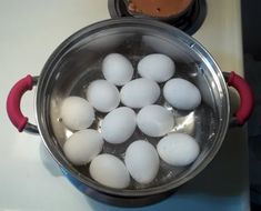 a pot filled with white eggs on top of a stove