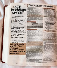 an open bible with handwritten notes on the pages and writing in black ink that reads our redember lives