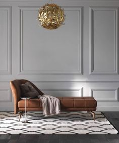 a living room with a couch, rug and chandelier