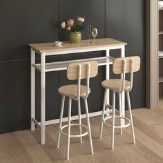 three stools and a table in a room with black walls, white shelves and wooden flooring