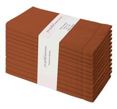 a stack of brown paper with a white ribbon