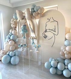 a room with balloons, cake and decorations on the wall in blue and white colors