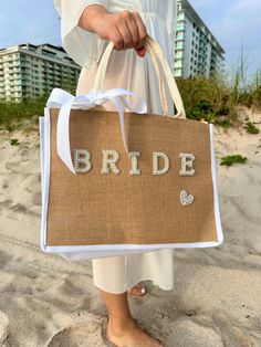 a woman carrying a bride bag on the beach