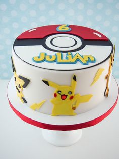 a pokemon themed birthday cake with pikachu on top