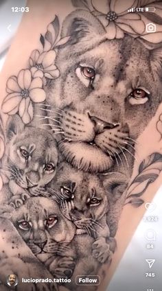 a woman's thigh with a lion and cubs tattoo on her leg, which is surrounded by flowers