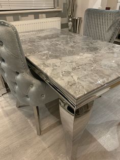 a marble dining table and chairs in a room