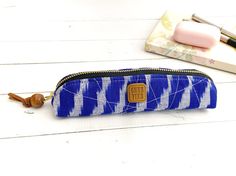 Check out this one-of-a-kind quilted slim pencil pouch from CHEZVIES. It is thin and slim that is perfect to slip into your backpack, purse, or tote. It can be used to keep your school essentials such as pencils, digital pens, highlighters, pens, markers, erasers, earpods, reading glasses, or your everyday essentials such as eyeliner, lip gloss, lipstick, brow pencil, etc.  Features: - Dimension: 7" W x 1.75"H x 1.5" D - Pattern/Design: Quilted, Ikat - Color: Blue, Grey - Closure: Metal Zipper - Zipper Pencil Pouch, Wallet With Coin Pocket, Board Pin, Cute Wallets, Pencil Pouch, Pen Case, Bags Purses, Office School, Pdf Sewing Patterns