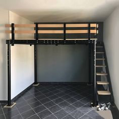 a loft bed with stairs in the middle and tiled flooring on the bottom level