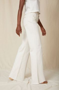 Make a statement in our best-selling high-rise, wide leg silhouette. With an easy fit though the hip and thigh, full inseam, slight distressing at the pockets and a raw frayed hem, they're your new everyday denim. Zip fly. WASH: WHITE OAK FIT & MEASUREMENTS: Inseam = 33" Front Rise = 13" Back Rise = 16" Leg Opening = 23" Measurements taken from size 27 Taliha is wearing a size 24 and is 5'10" Take your normal size for a full easy fit, or size down to be more fitted around the waist Fabric & Care Mid-rise Flare Jeans With Frayed Hem, High Rise Relaxed Fit Jeans With Frayed Hem, Spring Straight-cut Rigid Denim Flare Jeans, Spring Rigid Denim Flare Jeans With Straight Hem, Relaxed Fit Wide Leg Jeans With Frayed Hem, Chic High Rise Flare Jeans With Five Pockets, Spring Rigid Denim Pants With Frayed Hem, Chic Flare Jeans With Frayed Hem For Work, Chic Mid-rise Rigid Denim Flare Jeans