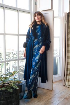 Our Yasmine dress is a stunning blue and metallic print maxi dress, with long fitted sleeves and a beautiful silhouette. It's completed with a flattering side split. It's the perfect dress to dress up with heels for those upcoming festive parties. Or keep it casual with a pair of boots, perfect for the winter season. The perfect versatile dress! 60% Viscose 35% Polyester 5% Elastane Machine wash 30c. Do not bleach. Do not tumble dry. Coo iron only. Long Sleeve Maxi Dress With Side Slits For Evening, Blue Long Maxi Dress For Formal Occasions, Blue Floor-length Maxi Dress With Side Slits, Long Blue Evening Dress, Long Blue Winter Dress, Elegant Winter Dresses With Side Slits, Blue Long Evening Dress, Winter Maxi Dress For Evening, Blue Long Dress With Side Slits